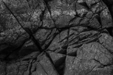 Close Up Of A Rugged Cliff Wall With Cracks.