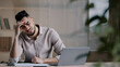 © Yuliia - Unhappy shocked arabian male worker look at laptop screen feeling nervous upset with bad news problems study failure exam frustrated young man confused unexpected error on computer losing online bets