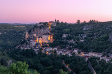 Dust Falls On 3 Levels Of Rocamadour Village And First Illumination From Sanctuaries Appears. Lot, Occitania, Southwestern France