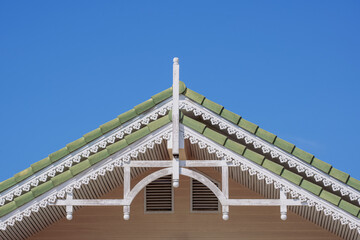 Wall Mural - Front view of the old vintage gable roof against blue clear sky background