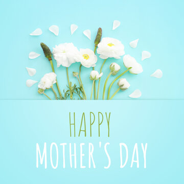 mother's day concept with white flowers over blue pastel background
