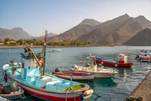 View Of Colourful Boats In Harbour And Mountains In Background, Puerto De La Aldea, Gran Canaria, Canary Islands