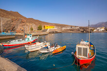 View Of Colourful Boats In Harbour And Mountains In Background, Puerto De La Aldea, Gran Canaria, Canary Islands