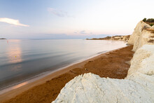 Calm Sea At Dawn Framed By Limestone Cliffs Overlooking The Gold Sand Of Xi Beach, Kefalonia, Ionian Islands, Greek Islands