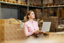 A Food Industry Worker Checking On Shipment On The Laptop In Warehouse.