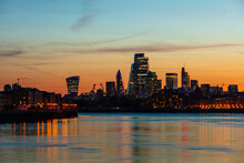 The City Of London Skyline At Sunset Reflecting In River Thames, London