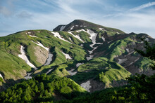Cusna Mountain With Lush Green Grass And Some Melting Snow Zone, Emilia Romagna