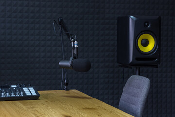 Podcast recording studio, with microphones and equalizer for recording online radio broadcasts, with black soundproof wall