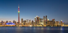Toronto Skyline Featuring The CN Tower At Night Across Lake Ontario, Toronto, Ontario