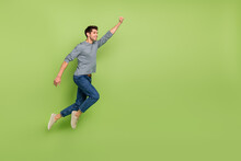 Full Body Photo Of Cheerful Cool Positive Super Male Flying To Save The World Isolated On Green Color Background