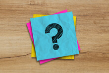 Crumpled Note Paper With Question Mark On Textured Wood Background