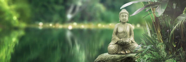 buddha statue on a rock lakeside, natural spa background with asian spirit, tranquility in green nat