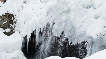 Wall Mural - Frozen winter siberian waterfall. Ice formation with white snow. 