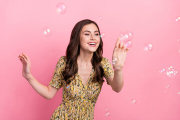 Canvas Print - Photo of impressed young brunette lady play wear yellow dress isolated on pink color background