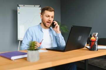 Wall Mural - Disabled Businessman Sitting In Wheelchair Using Computer At Workplace