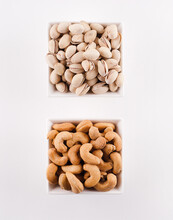 Two Bowls Of Nuts; Pistachios And Cashews.