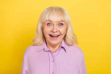 Poster - Portrait of attractive cheerful amazed grey-haired granny good news reaction isolated over bright yellow color background