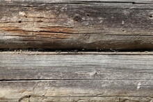 Weathered Surface Of The Wall Of An Old Wooden Log House Close-up. The Texture Of Log Walls In Close-up. The Background Of A Wooden Log House.