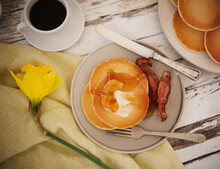 Spring Breakfast Of Pancakes With Butter And Syrup, Bacon And Coffee