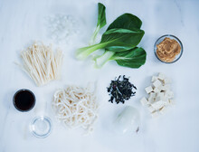 Asian Noodle Soup Ingredients With Mushrooms, Bok Choy, Noodles, And Onion