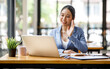 © David - Asian Businesswoman have business meeting via looking at webcam making conference video call in a work
