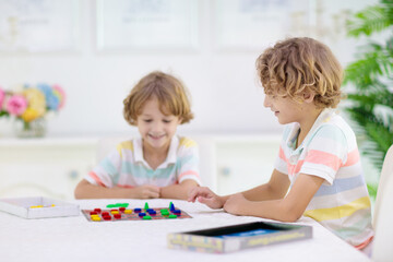 Wall Mural - Family playing board game. Kids play.