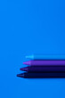 Leinwandbild Motiv top view of blue gradient crayons on bright background.