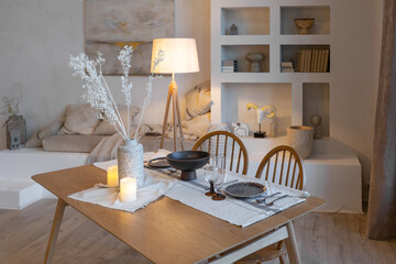 Wall Mural - cozy warm home interior of a chic country house with an open plan, wood finishes, warm colors and a family hearth. view of the dining area, table and table setting