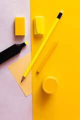 Sticker - top view of stationery and marker pen near paper note on yellow and white.