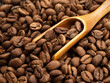 Coffee beans background and wooden spoon with coffee