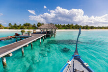 Perfect Island Paradise Beach Maldives, Travel. Long Jetty And A Traditional Dhoni Boat At Pier With Palm Trees, Maldives Island. Beautiful Panoramic Tropical Landscape With Sunny Turquoise Ocean.