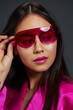© SHOTPRIME STUDIO - Brunette posing pink mini dress charm sunglasses Gray background