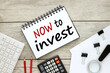 © Svetlana - now to Invest. open notepad with text next to calculator