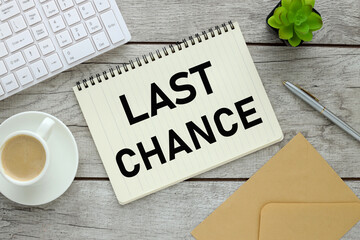 Last Chance. notepad with text near coffee cup and white keyboard