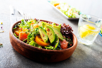 Wall Mural - Salad with avocado, tomatoes and fresh greens