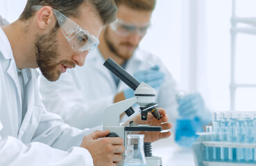 Wall Mural - biologist explores the substance under the microscope