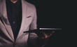 © Panithan - Close up hand of businessman with tablet. Concept of technoloy for business.