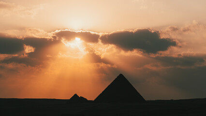 great pyramid of Mikerina in Cairo, Egypt. Pyramids of Menkaura against cloudy sky in the evening at a beautiful sunset