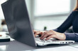 © undrey - Female hands typing on a laptop keyboard