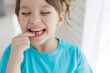 The kid lost a tooth. Baby without a tooth. Portrait of a little girl no tooth. High quality photo