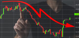 Fototapeta Młodzieżowe - Businessman hand making a decrease chart. Concept of economic downturn. Global financial crisis