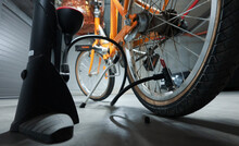 Inflating The Rear Wheel Of A Bike In An Underground Garage. Home Bike Maintenance.