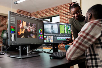 Poster - Post production department leader advising colleague to improve colors and frames quality of footage. Creative professional video editors collaborating in order to finish film project upon deadline.