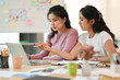 © bongkarn - Two female best friends searching the information on laptop