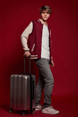 Young excited caucasian man tourist with suitcase