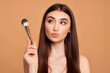 canvas print picture - beautiful young woman holding make-up brush
