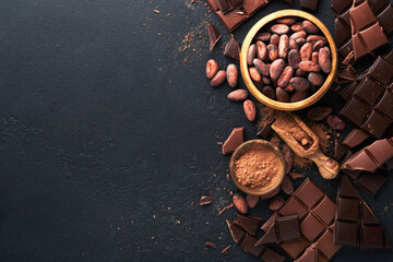 Chocolate . Composition of cocoa powder, grated and bean cocoa bars and pieces of different milk and dark chocolate on black background. Baking Chocolate Texture. Top view with copy space. Mock up.