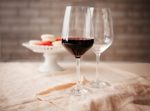 Red Wine Glasses With Macaroons In The Background