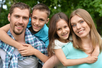 Sticker - Portrait of happy young family in summer  park