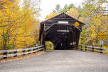 Old Wooden Covered Bridge In The Countryside Of New Hampshire, USA, On A Cloudy Autumn Day. Fall Foliage.
